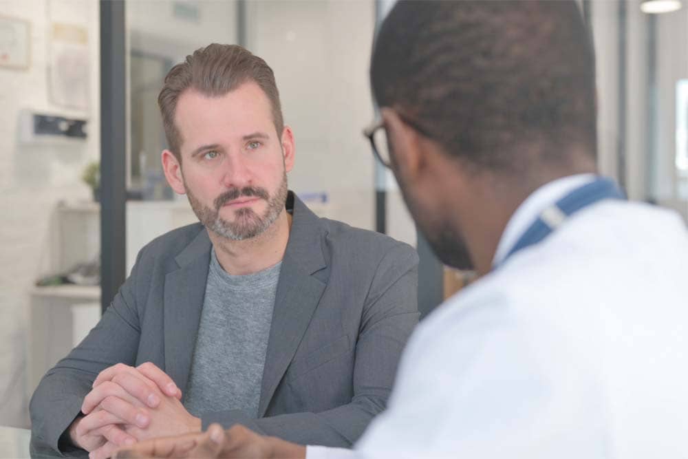 Man learning about TRT in Columbia MD during a 2026 health consultation