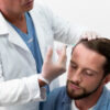 Doctor performing hair restoration treatment using PRP injections on male patient’s scalp