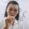 Scientist drawing chemical molecular structure representing bioidentical hormones