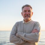 Confident older man standing outdoors with arms crossed representing a positive TRT timeline and testosterone replacement results